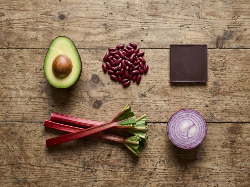Avocado, raw beans, chocolate, rhubarb, and onion arranged as a toxic-foods reference for chicken keepers